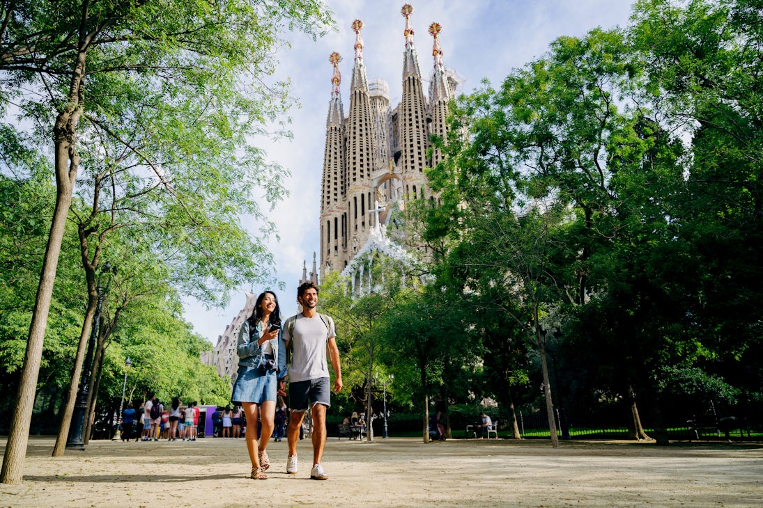 Walking through Barcelona park near Sagrada Familia.
